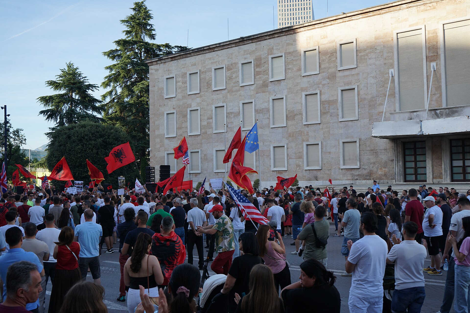Demonstrators wave Albanian and European Union flags outside a government building in Tirana during a Flamingo movement protest — Albania student protests file photograph