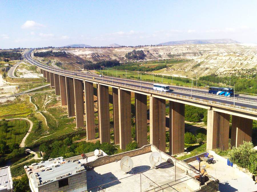Buses travel on the Hama-Homs highway near Rastan Bridge in a file photo for the Syria Homs bus attack report