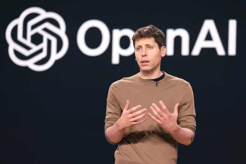 OpenAI CEO Sam Altman speaking in front of the OpenAI mark during the OpenAI revenue Nasdaq selloff debate