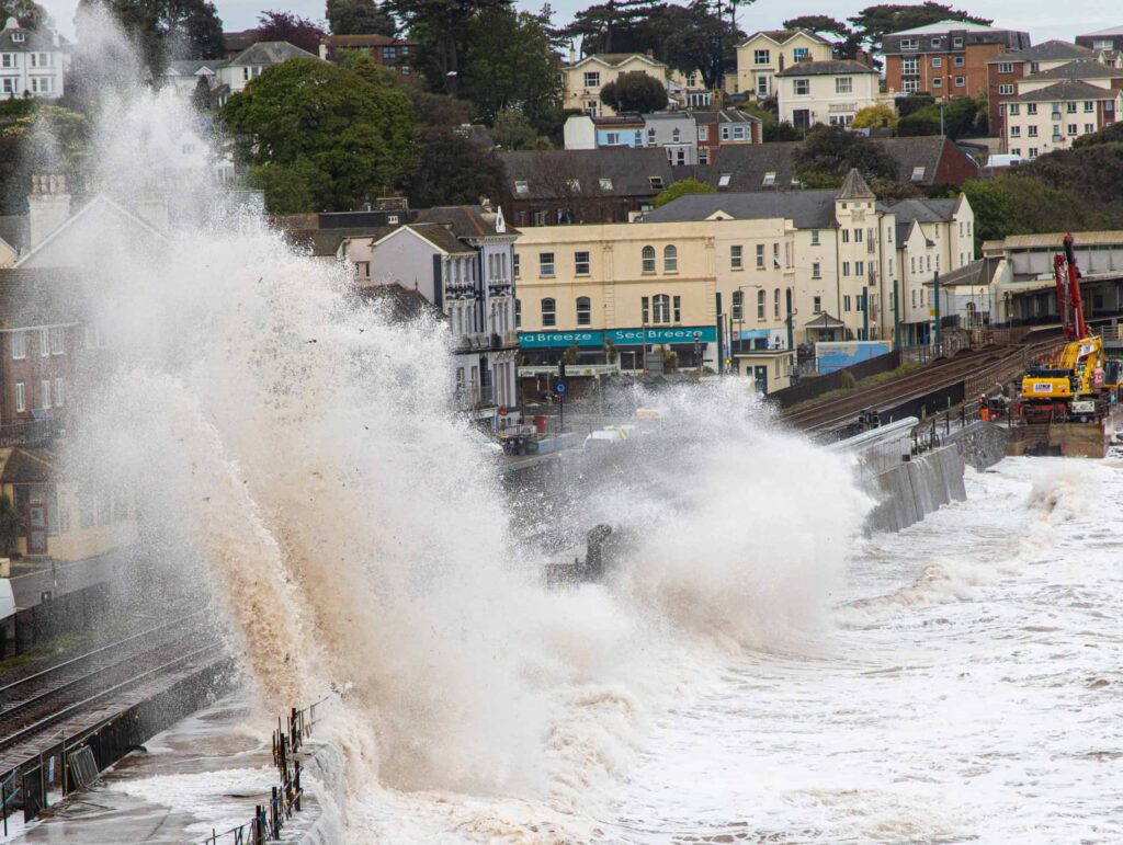 Storm waves crash over the sea wall and railway at Dawlish in Devon — the South West coast in the Storm Austen power cuts