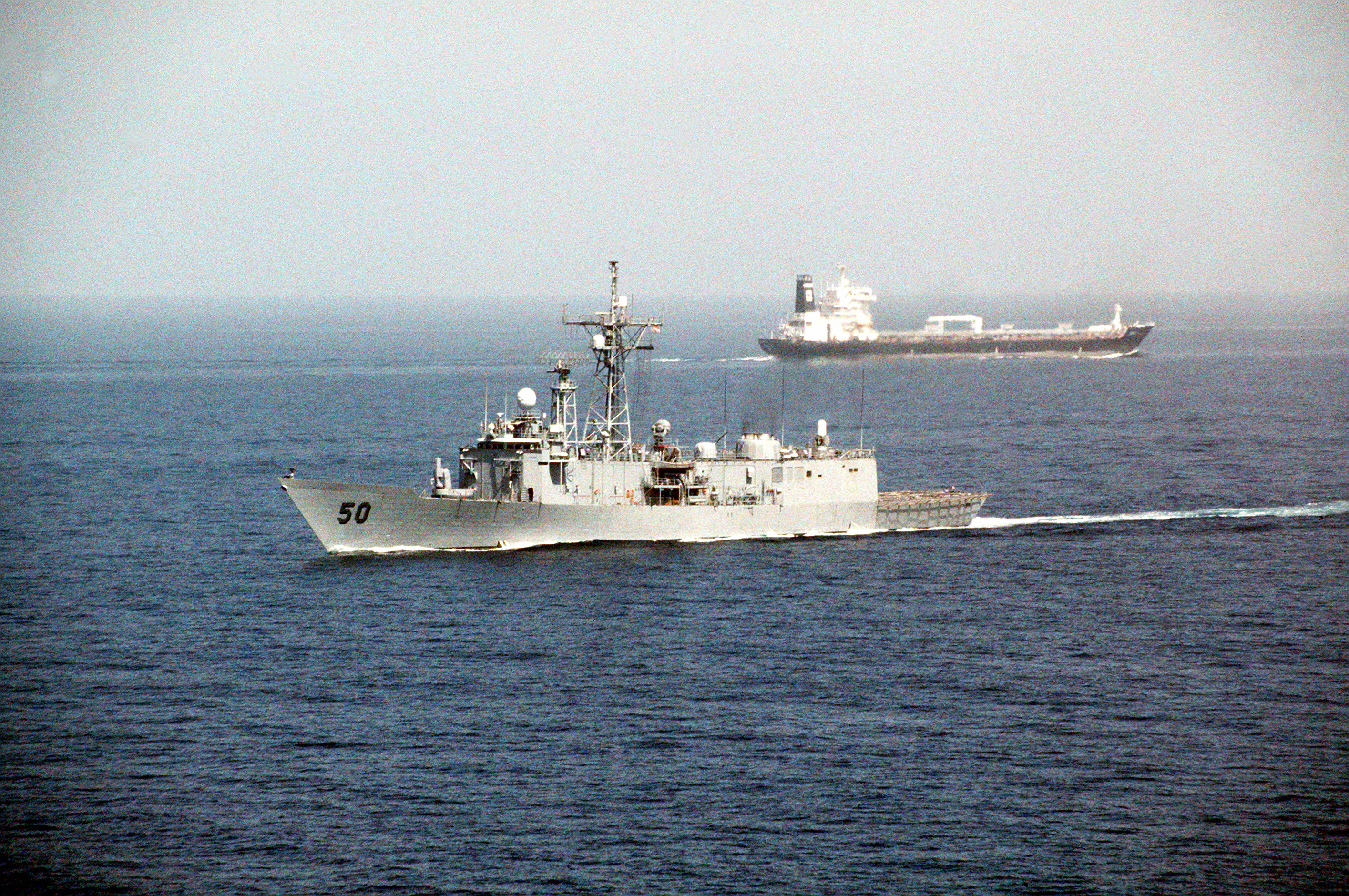 US frigate USS Taylor passing a tanker after transiting the Strait of Hormuz — file photo for the seafarers trapped Strait of Hormuz report