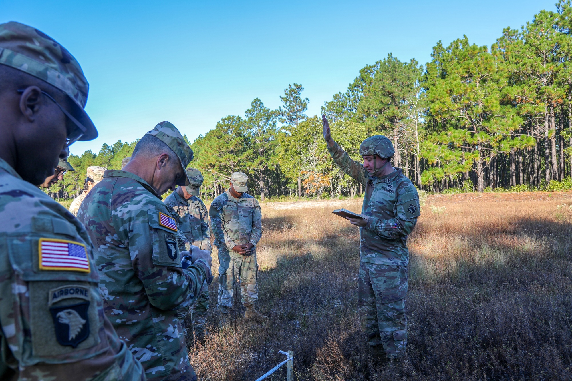 Chaplain Maj. Warwick Fuller leads a prayer to consecrate a battlefield temporary interment site at Fort Bragg