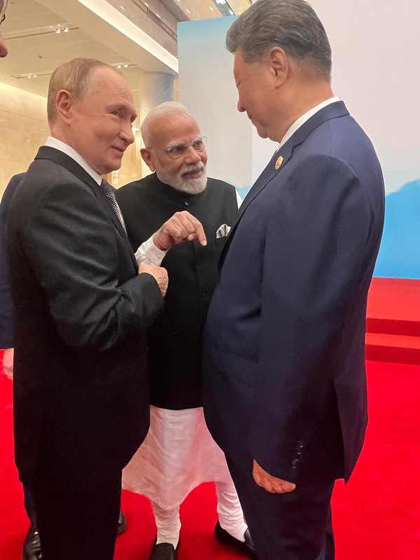 Russia's Vladimir Putin and China's Xi Jinping talking with India's Narendra Modi at the SCO summit, as Trump says Russia and China are not helping Iran