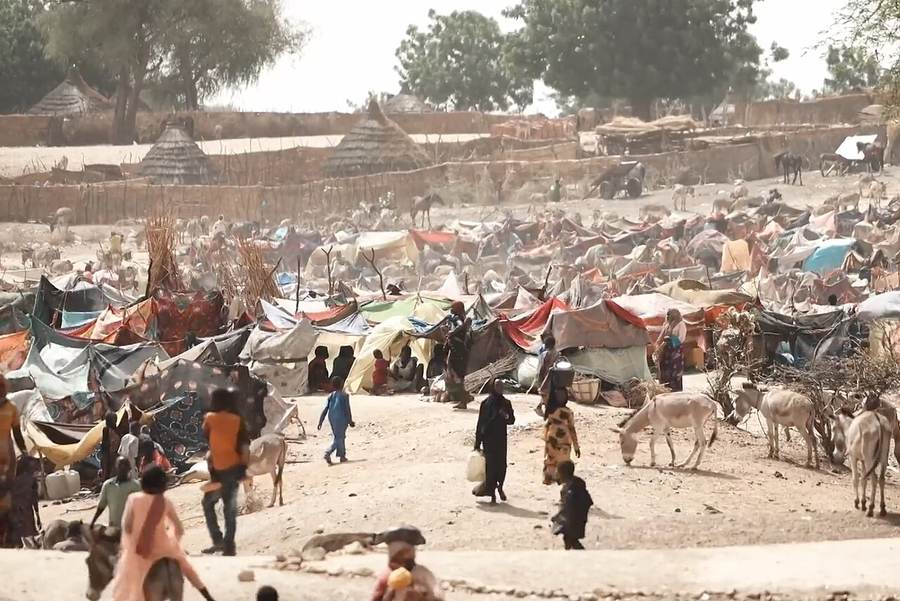A Sudanese refugee camp in Chad with rows of shelters on dry ground