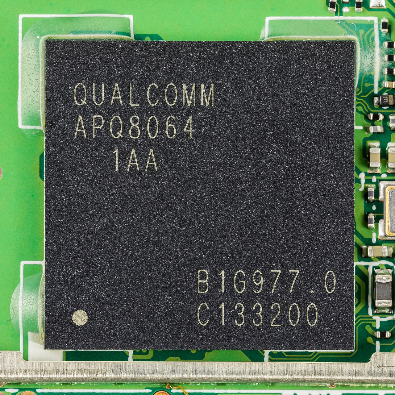 Qualcomm Snapdragon chip on a device main board, illustrating Qualcomm patent licensing and Apple's modem transition