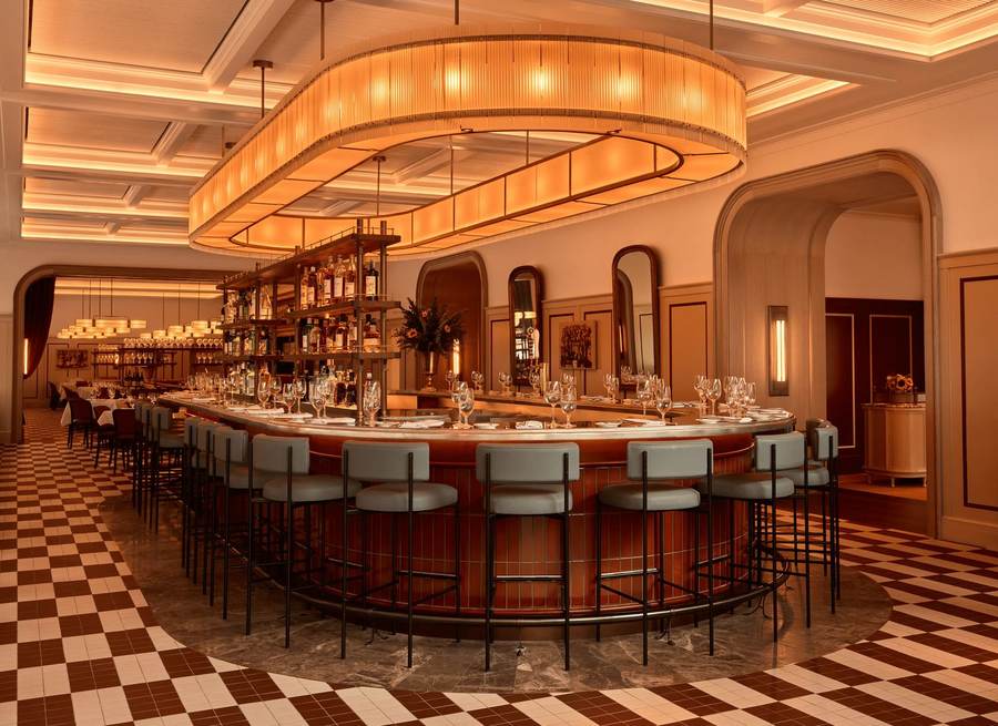 Oval bar and theatrical amber lighting inside Daniel Boulud's new Brasserie Boulud near Lincoln Center in New York City