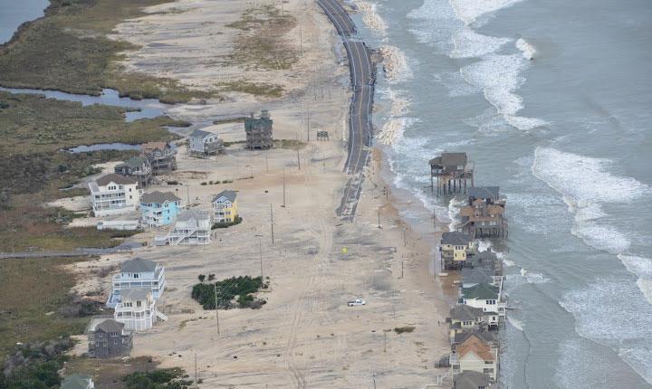 An aerial view of ocean overwash tearing at the dune line and roadway on the Outer Banks — erosion from September's nor'easter has left beaches with less protection this time, file photo