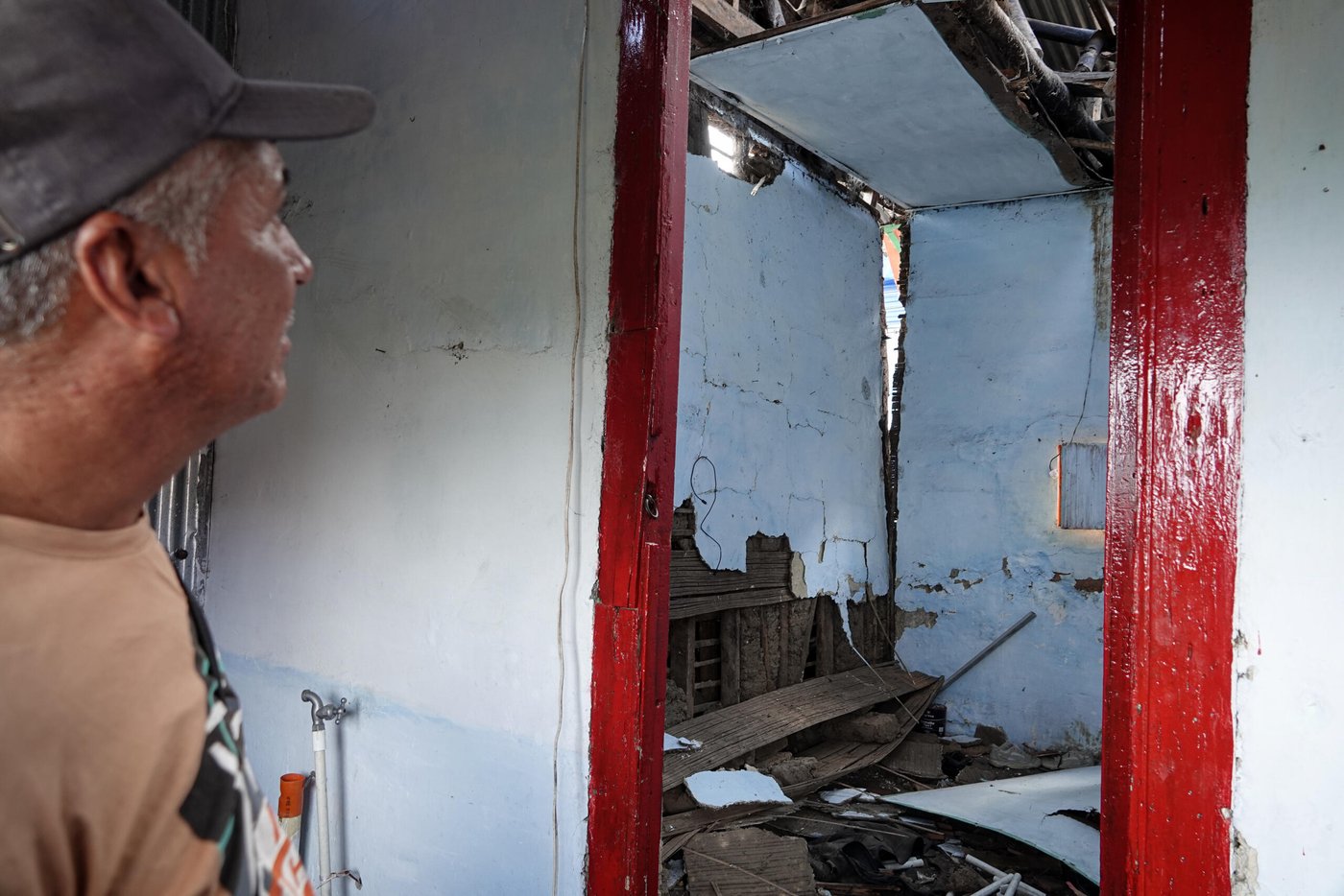 Rescue volunteer standing amid earthquake ruins in western Colombia after the August 10, 2026 quake