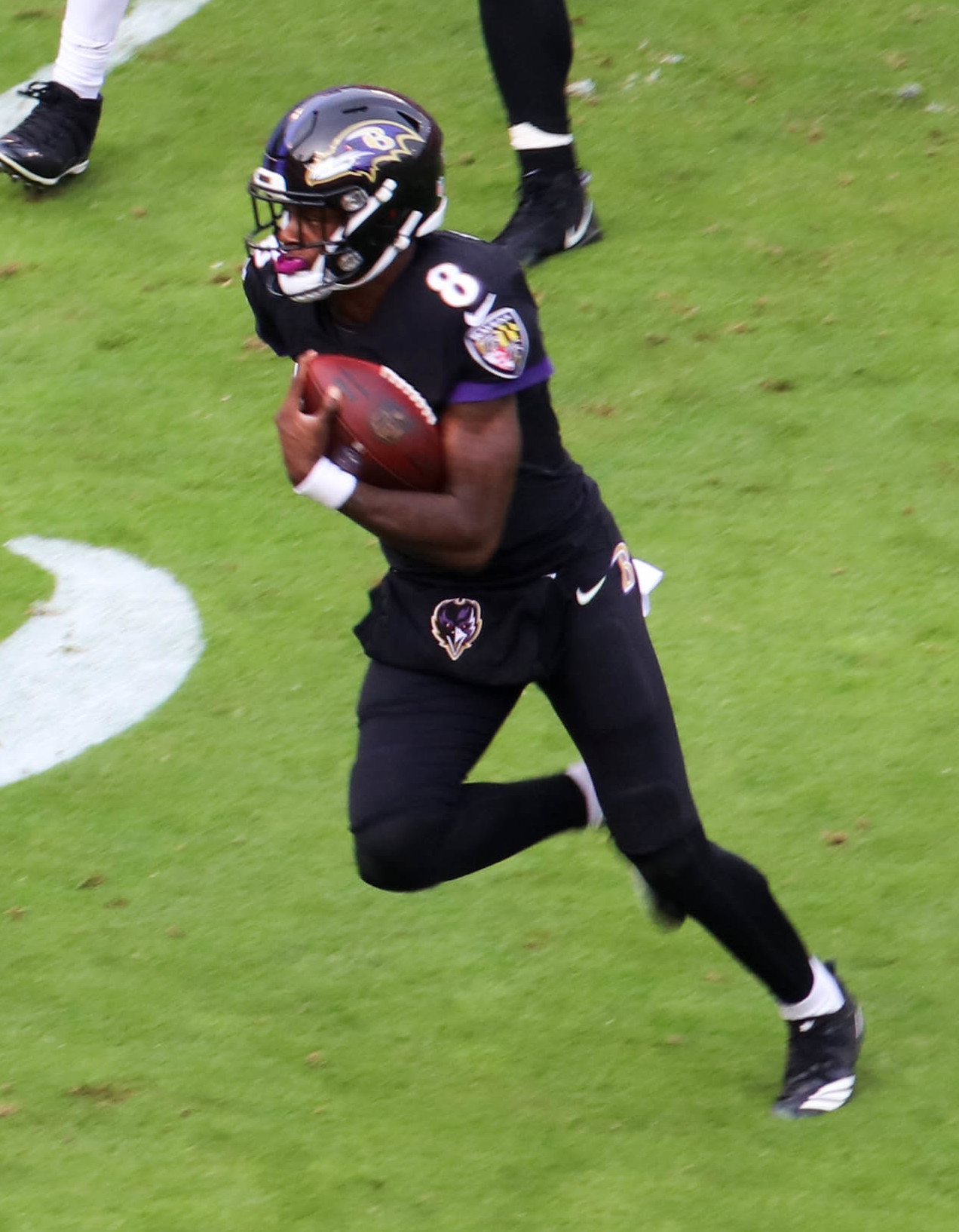 Lamar Jackson running with the ball, the Ravens quarterback in the Lamar Jackson ruled out Bengals story