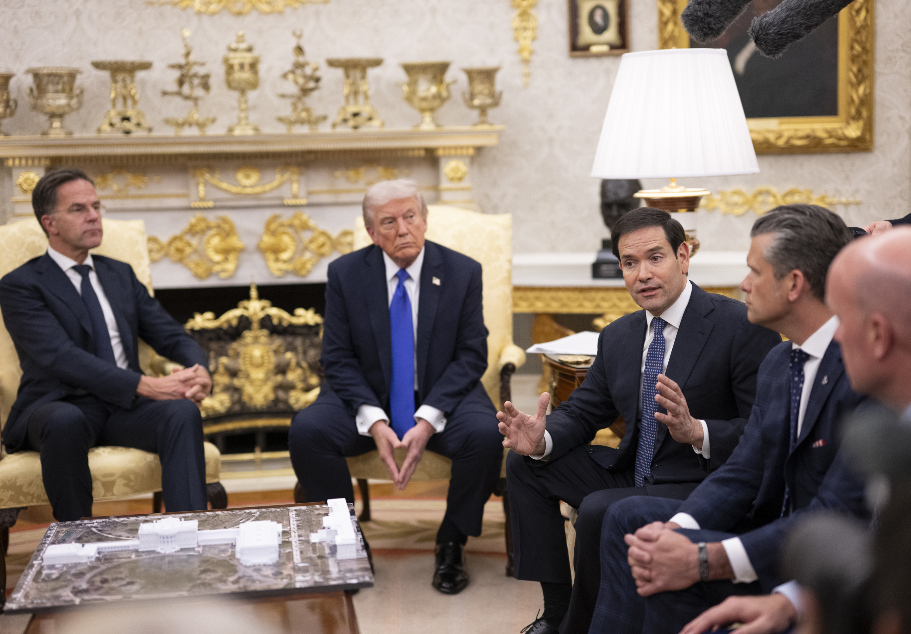 President Donald Trump speaks with members of the media in the Oval Office, in the week he blamed immigration for France's protests at the White House and at a Kansas rally