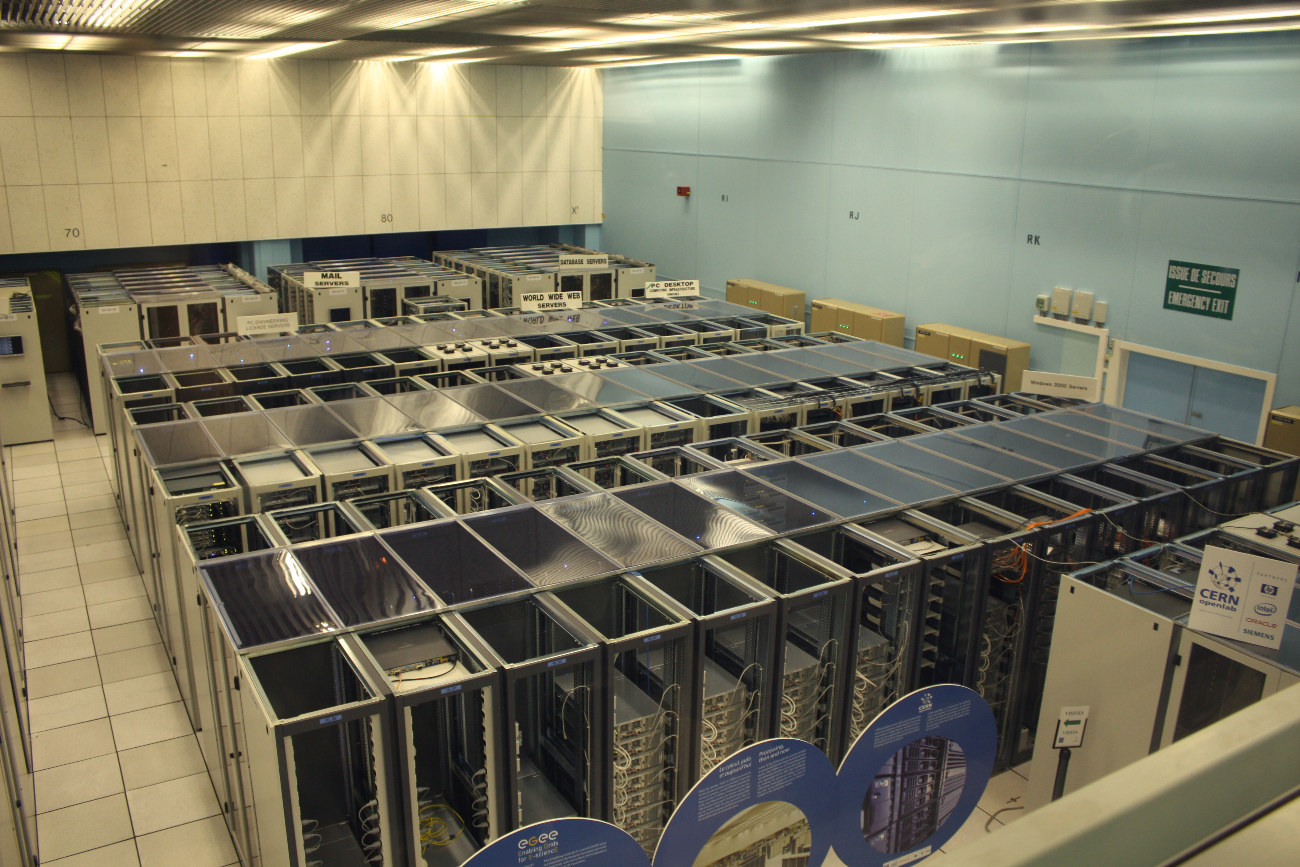 Rows of server racks in a large data centre hall — AI server demand behind the SMCI stock surge