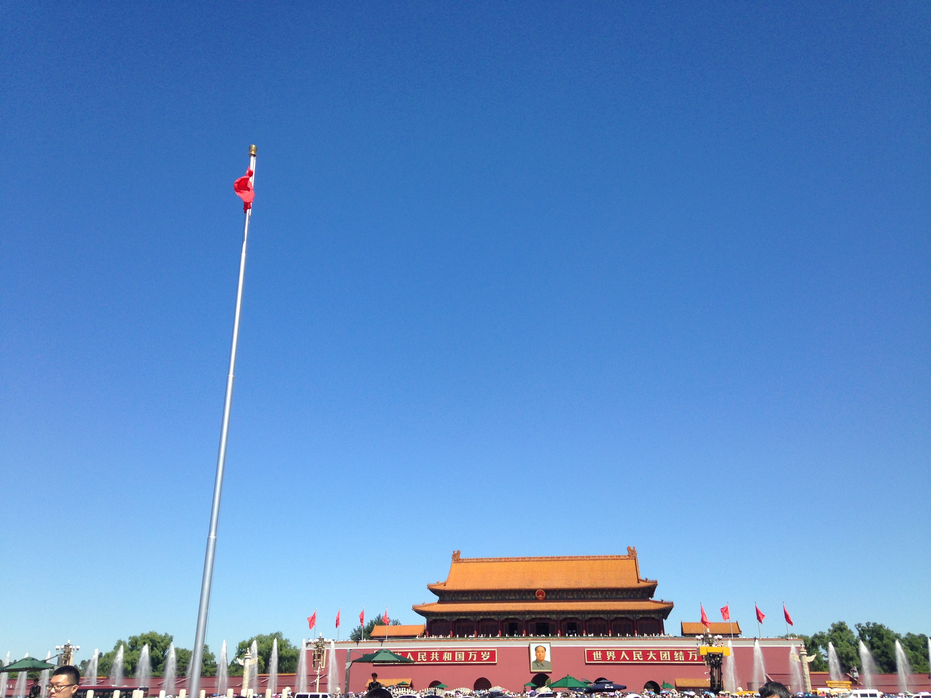 China's national flag flies over Tiananmen Square in Beijing, with the Gate of Heavenly Peace behind it
