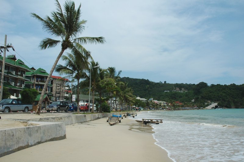 The southern end of Patong beach in Phuket, Thailand, with the hills behind the town that funnel monsoon runoff into its streets