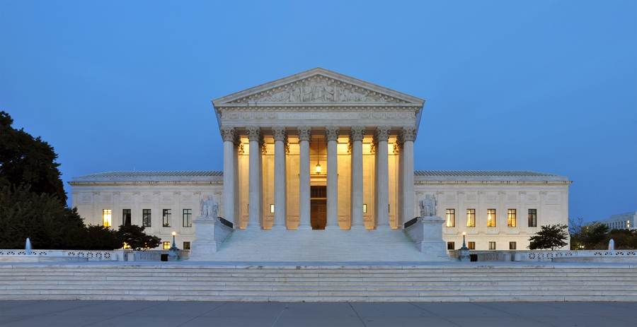 The U.S. Supreme Court building at dusk, as the justices take up the Supreme Court mandatory immigration detention case