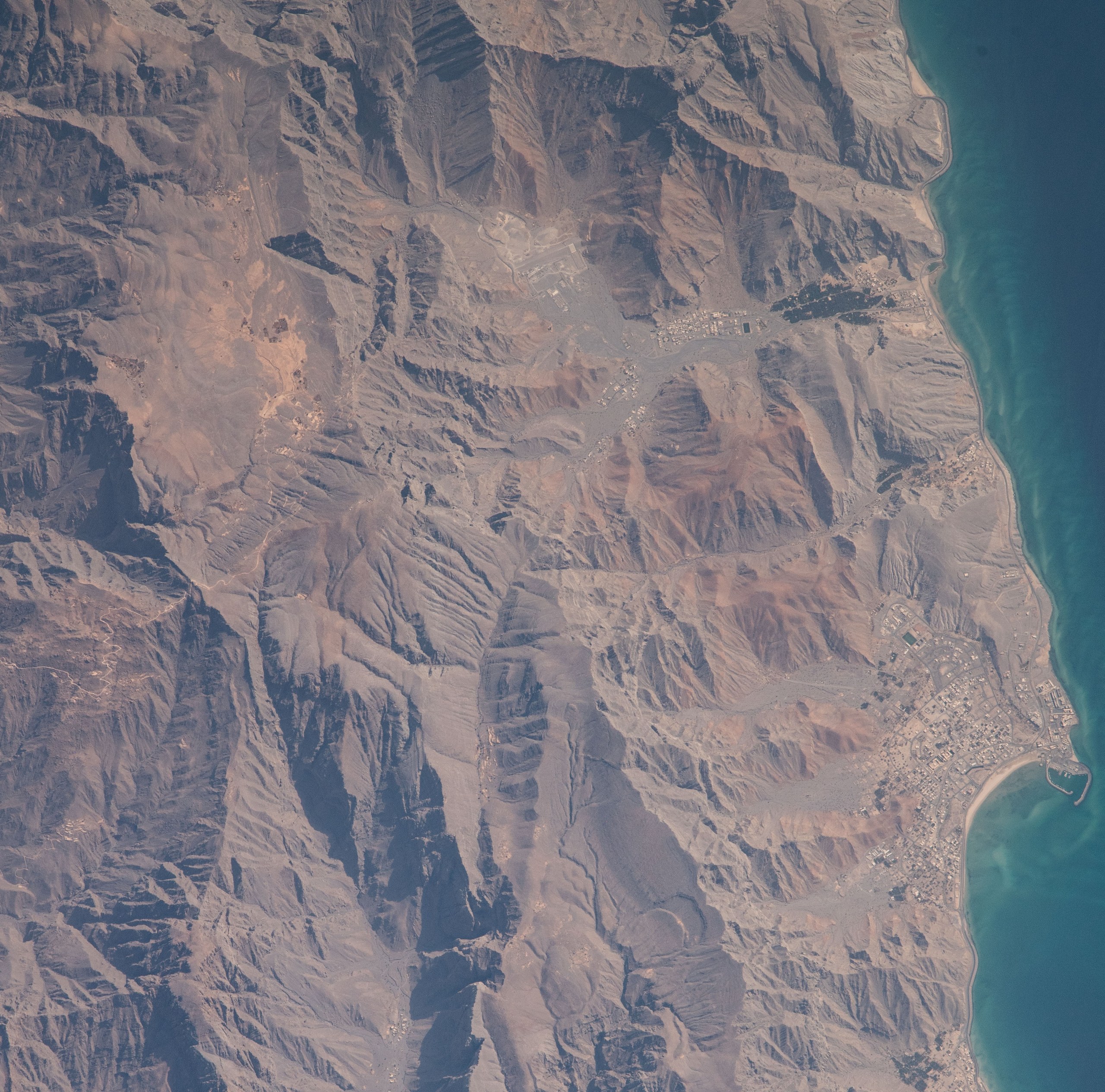 Bukha town and Bukha Port on Oman's Musandam coast photographed from the International Space Station — tanker struck off Oman