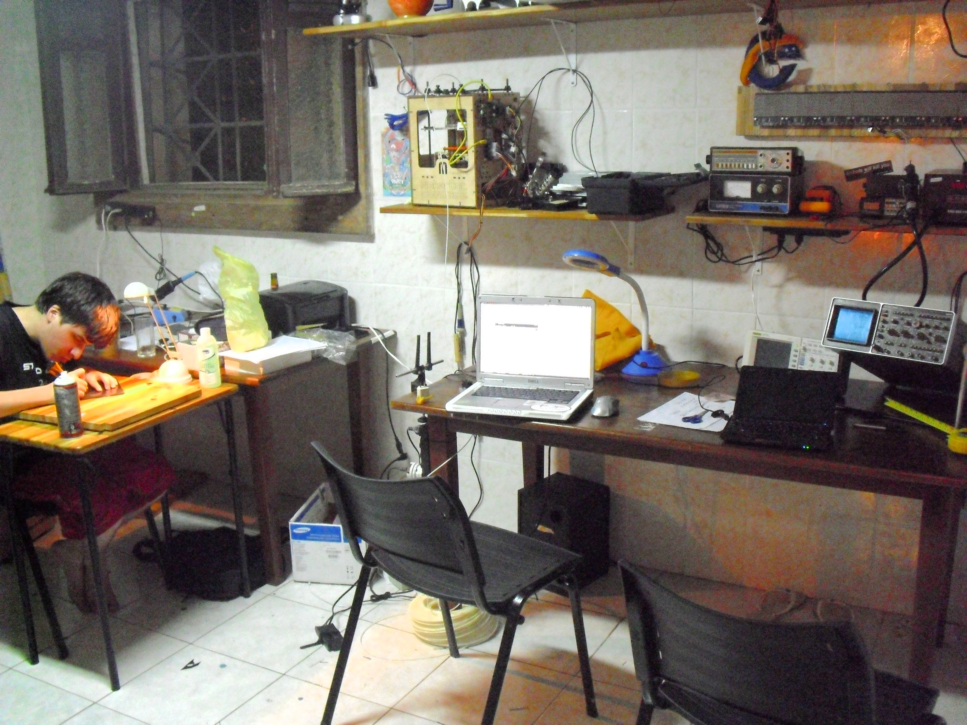 BrainChip AKD1500 SPI neuromorphic chip — electronics workbench with oscilloscope and laptops, file photo