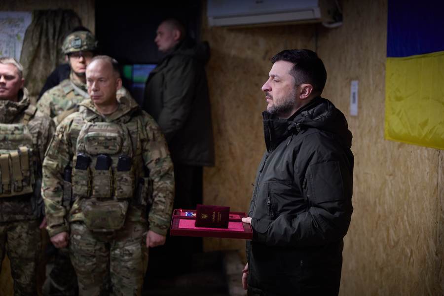 Volodymyr Zelenskyy presents a state award to a Ukrainian soldier at a forward command post, in an official photo released by the Ukrainian presidency