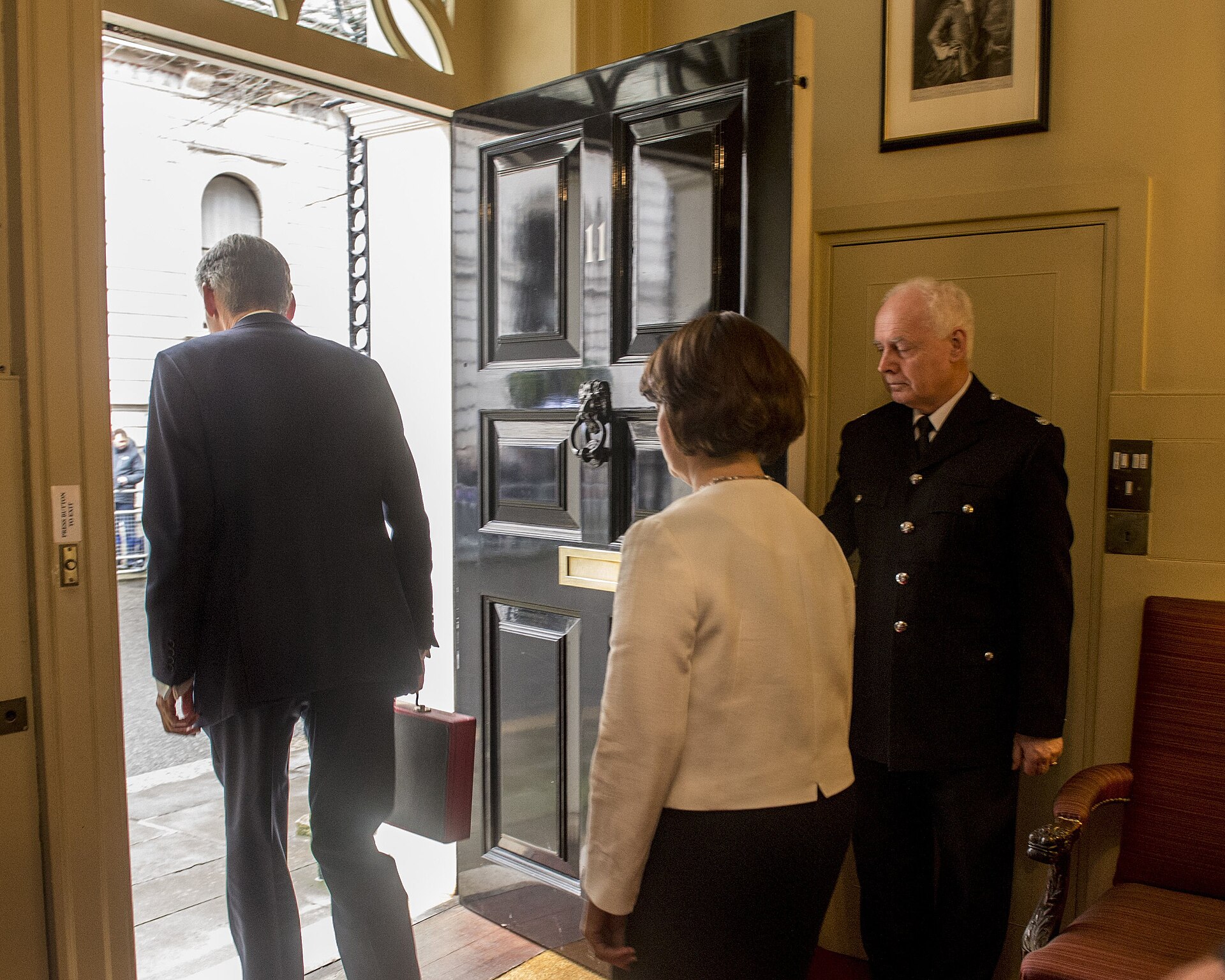 A Chancellor of the Exchequer leaves 11 Downing Street carrying the red Budget box — the Treasury door from which Healey budget Ukraine aid was prepared
