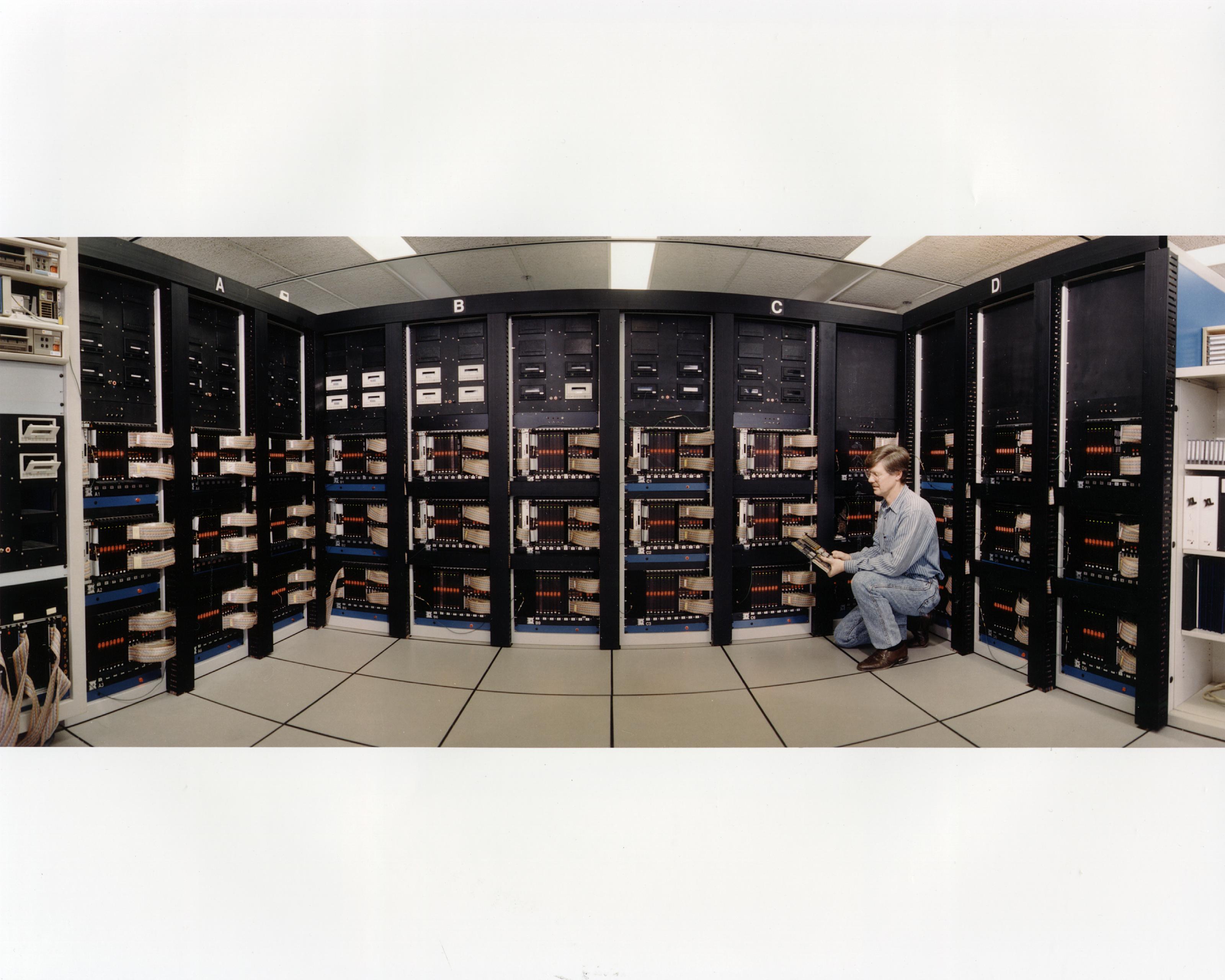 A supercomputing hall with rows of server racks