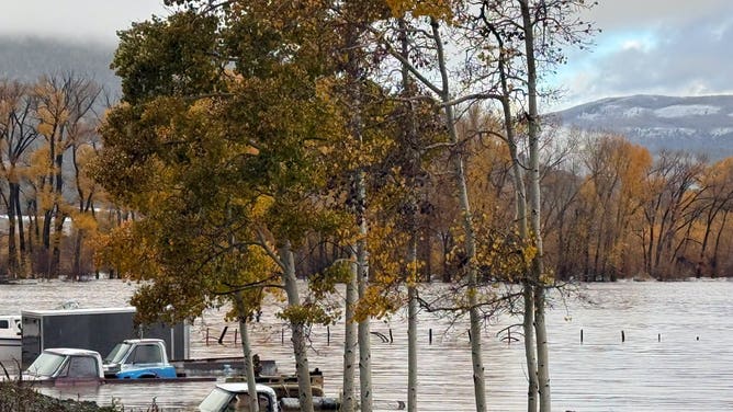 Four Corners flooding rescues — floodwater submerging vehicles and trailers in South Fork, Colorado, on October 23, 2026