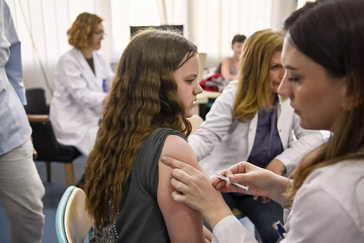 Health worker giving an HPV vaccine to reduce HPV cancer risk