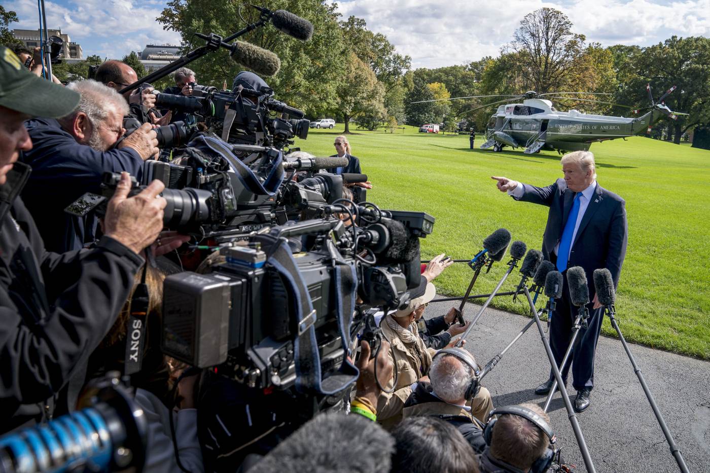 President Donald Trump answers reporters near Marine One on the White House grounds