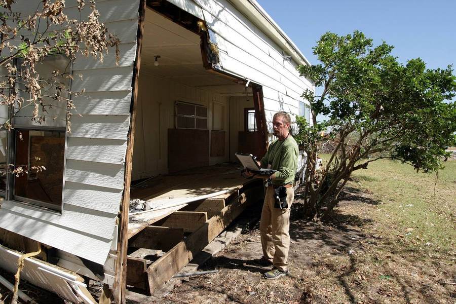 A housing inspector examining a home in the field