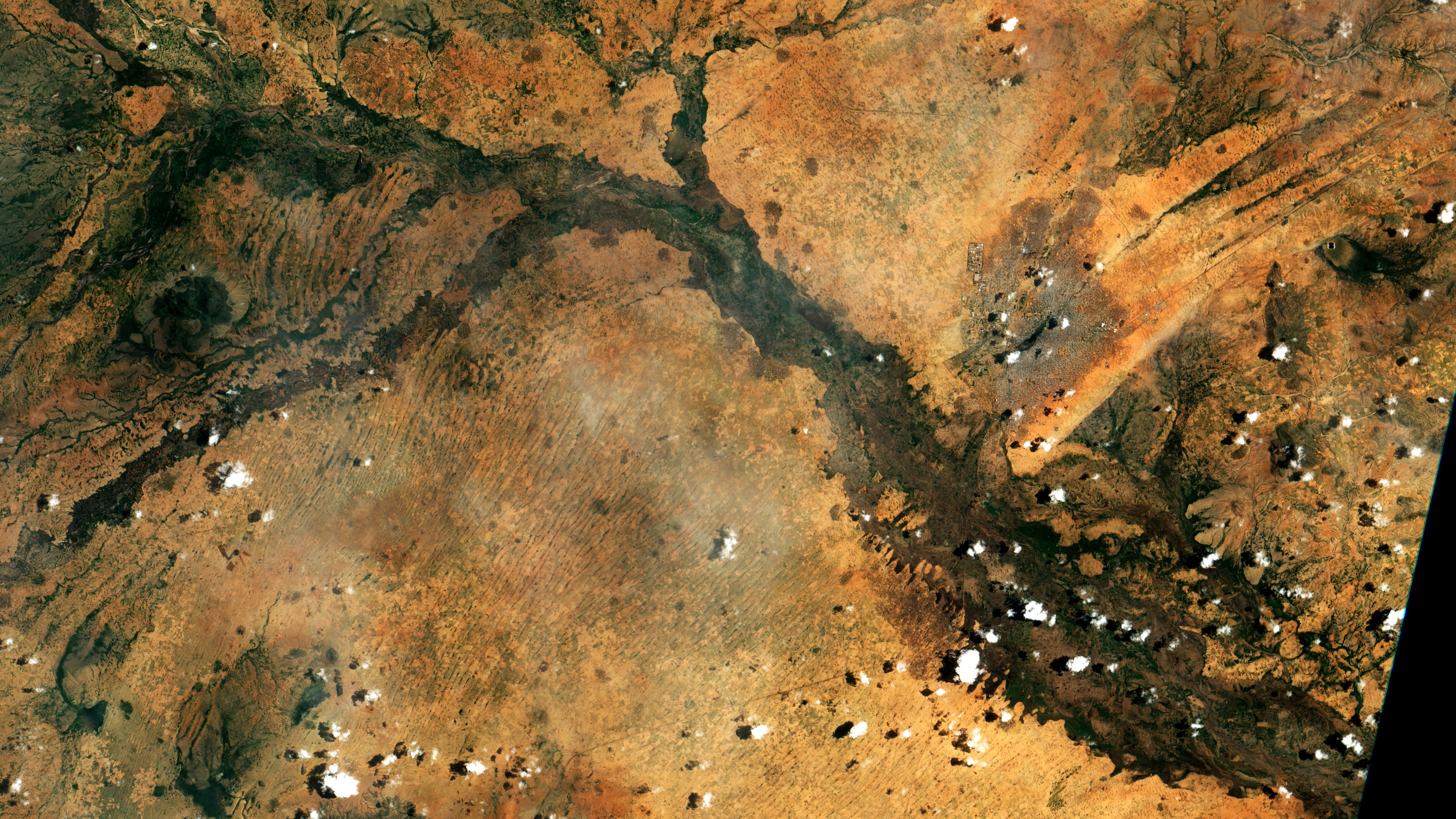 Satellite view of El Fasher, North Darfur, Sudan, surrounded by arid land and seasonal watercourses