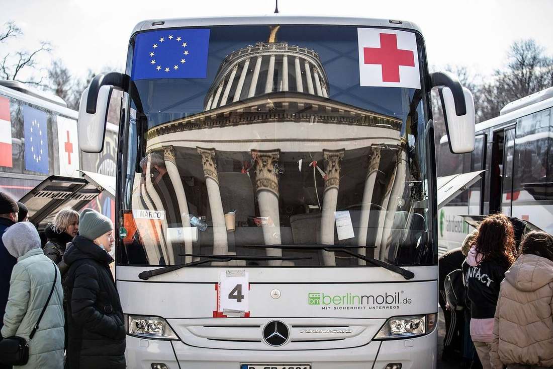 Residents of Kyiv board evacuation transport — more than 20,500 Ukrainian children have been verified as deported to Russia, with independent estimates running far higher
