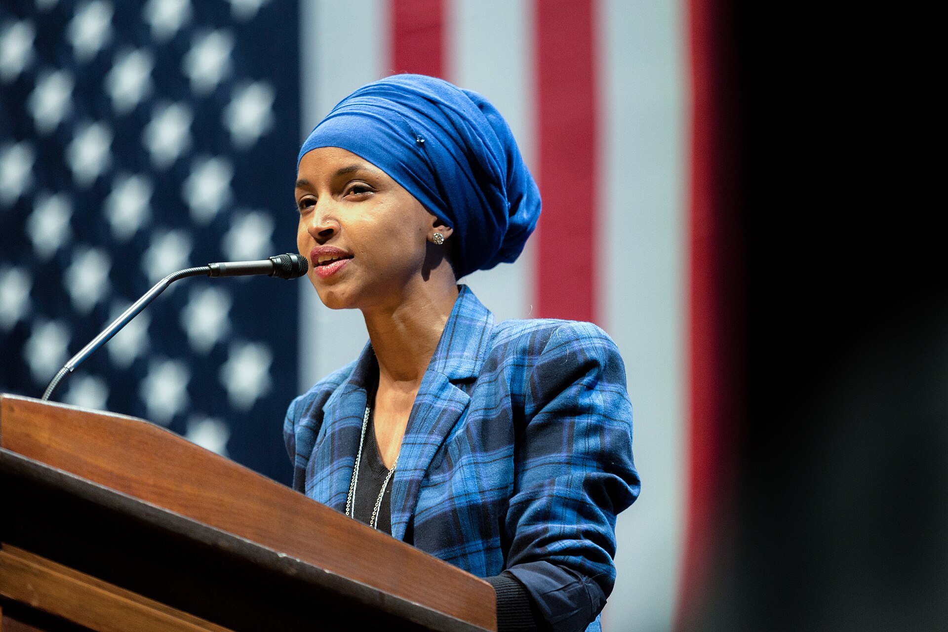 Rep. Ilhan Omar speaking at a podium with a U.S. flag behind her, in a 2016 file photo