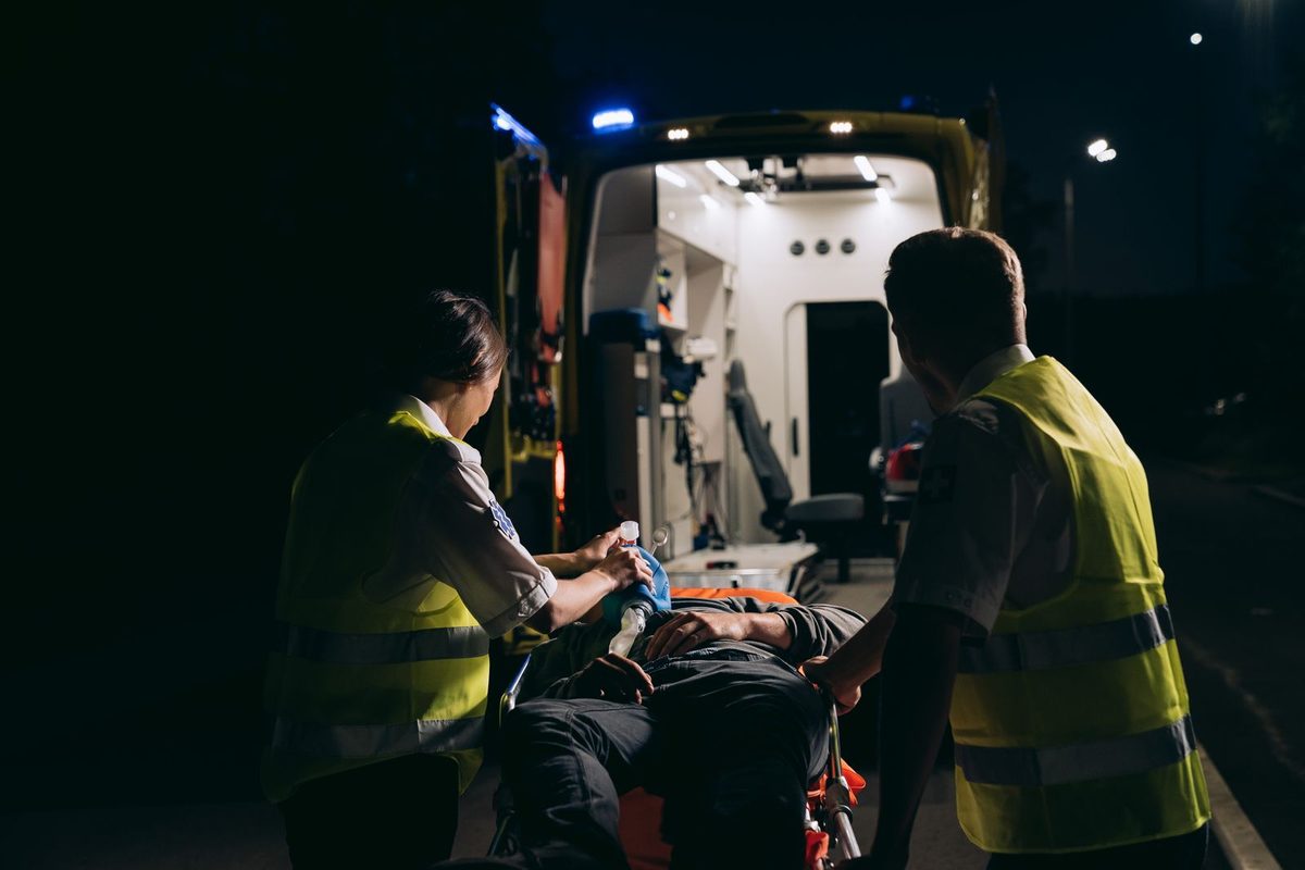 Paramedics loading a patient into an ambulance at night &mdash; Robert Kelker-Kelly 911 audio cardiac arrest final moments