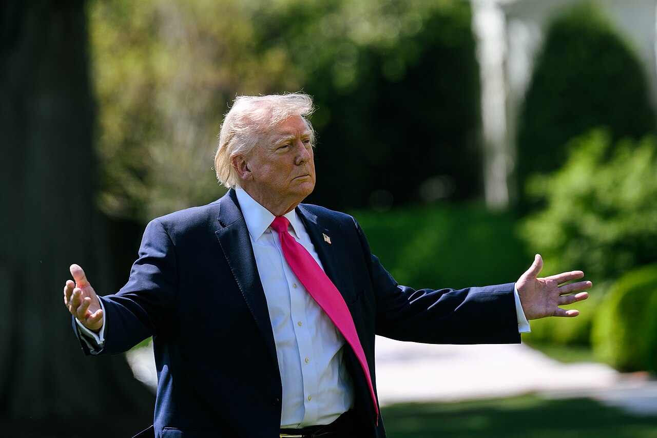 President Donald Trump gestures as he speaks with reporters on the South Lawn of the White House