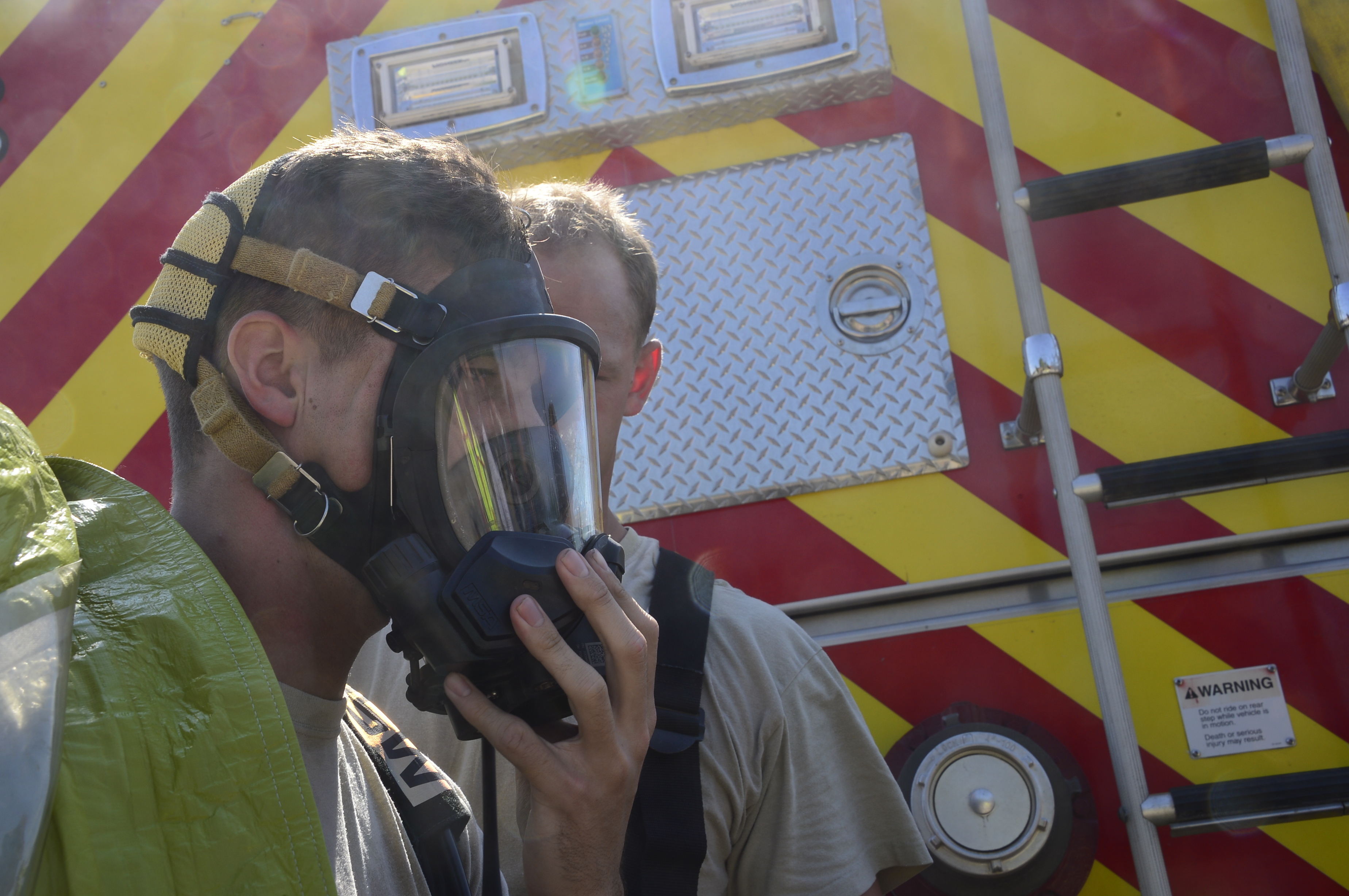 Toledo chemical leak evacuation — a firefighter fitting a respirator mask during hazmat training