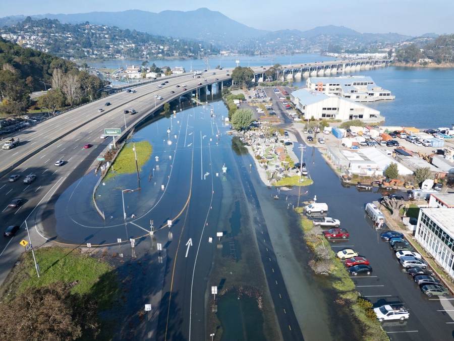 King Tide flooding covers lanes near the Highway 101 and Highway 1 intersection in Mill Valley, California
