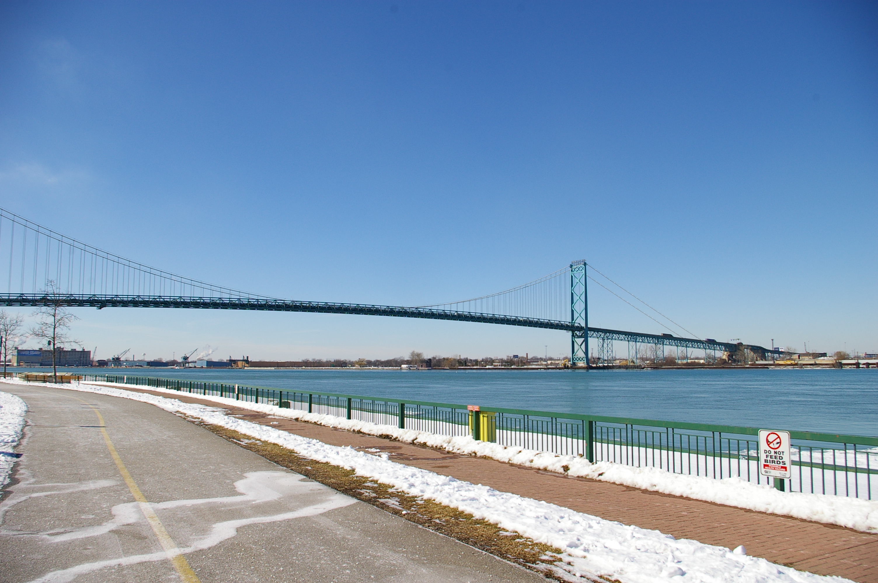 Ambassador Bridge between Windsor Ontario and Detroit Michigan in winter — the busiest Canada US trade crossing, linking the auto industries at the heart of the tariff war