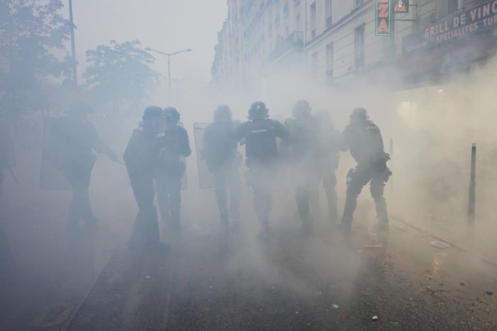 Riot police advancing through tear gas during the France protests October 2026 in Paris