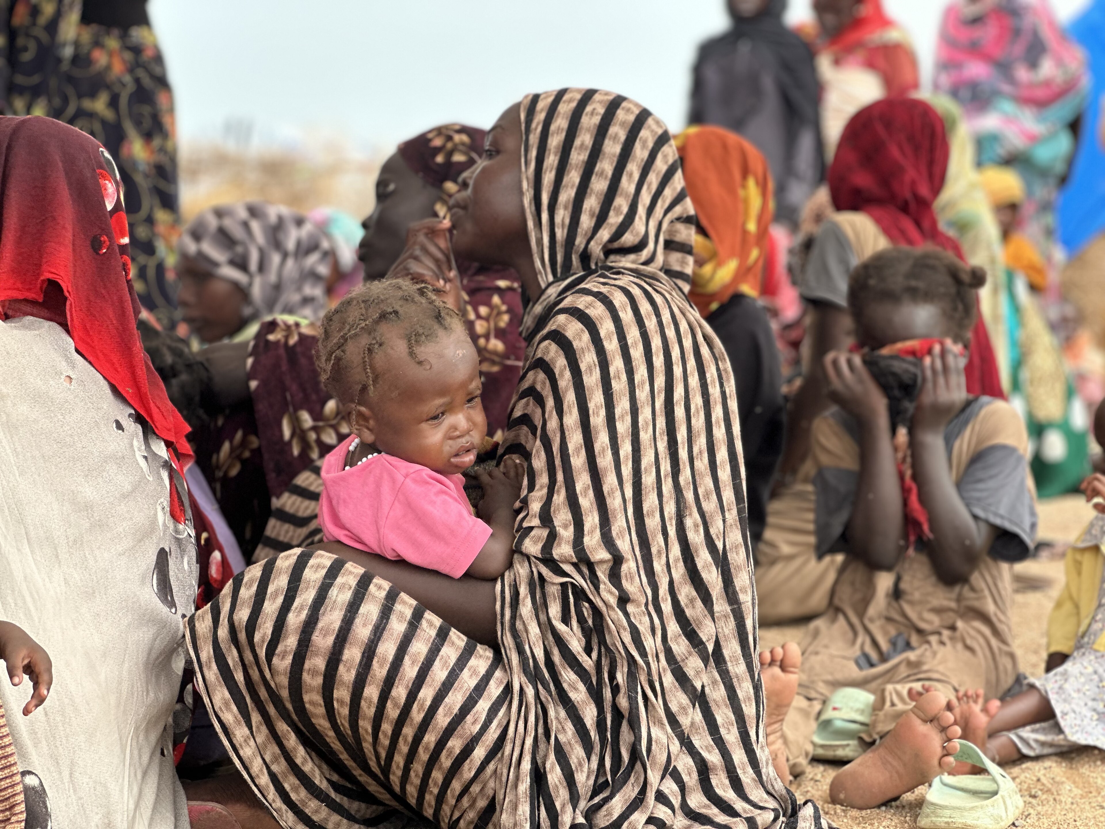 Women and children from Darfur waiting for a humanitarian aid distribution in Tawila, North Darfur, Sudan