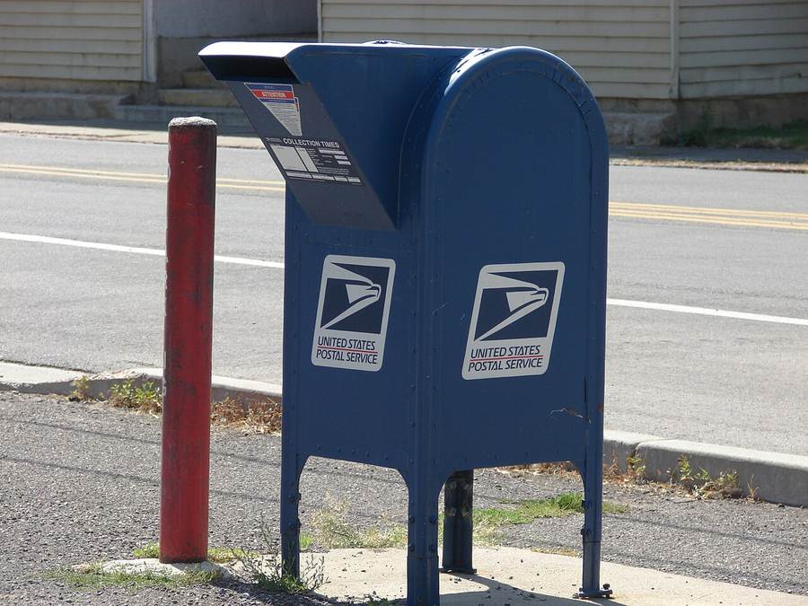 A blue USPS collection mailbox — Trump's $500 Obamacare refund checks are arriving by mail with no application needed