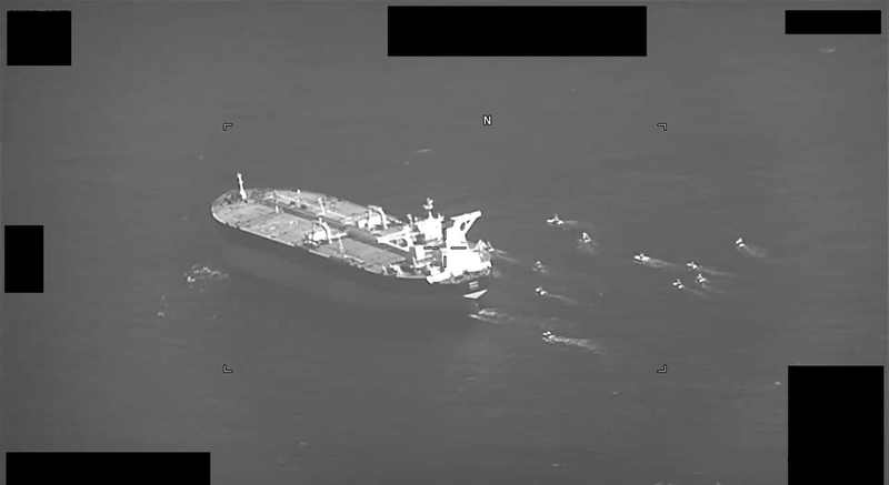 Iranian Revolutionary Guard fast-attack craft swarm the Panama-flagged oil tanker Niovi in the Strait of Hormuz in a U.S. Navy surveillance image, amid the shipping risk around Iran oil exports