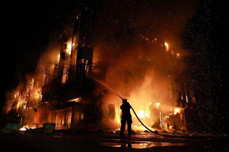 A rescue worker fighting a fire at the Intrade trade center in Zaporizhzhia after a Russian drone strike