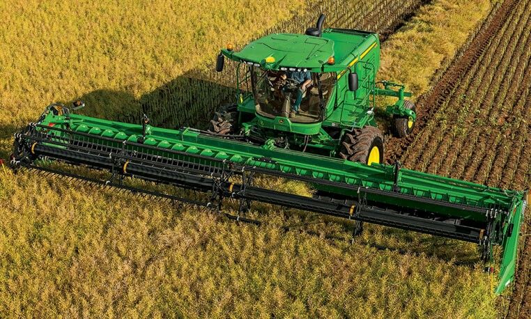 A John Deere combine harvesting wheat — Deere was among the companies whose websites Reuters identified as targeted through the exposed panels, file photo