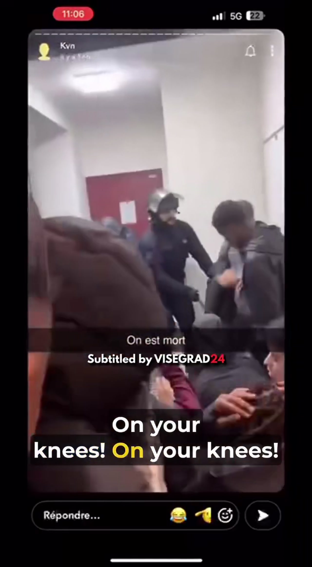 Helmeted police officers order a group of young men onto their knees in a hallway in the second France looter video clip