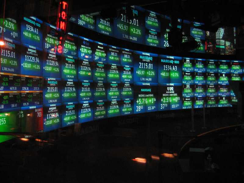Nasdaq market screens representing AI stocks tumble during the OpenAI revenue Nasdaq selloff
