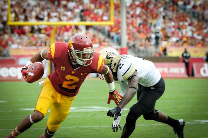 USC Trojans and Colorado Buffaloes line up at the Coliseum in a file game-action photograph illustrating USC football's home stage