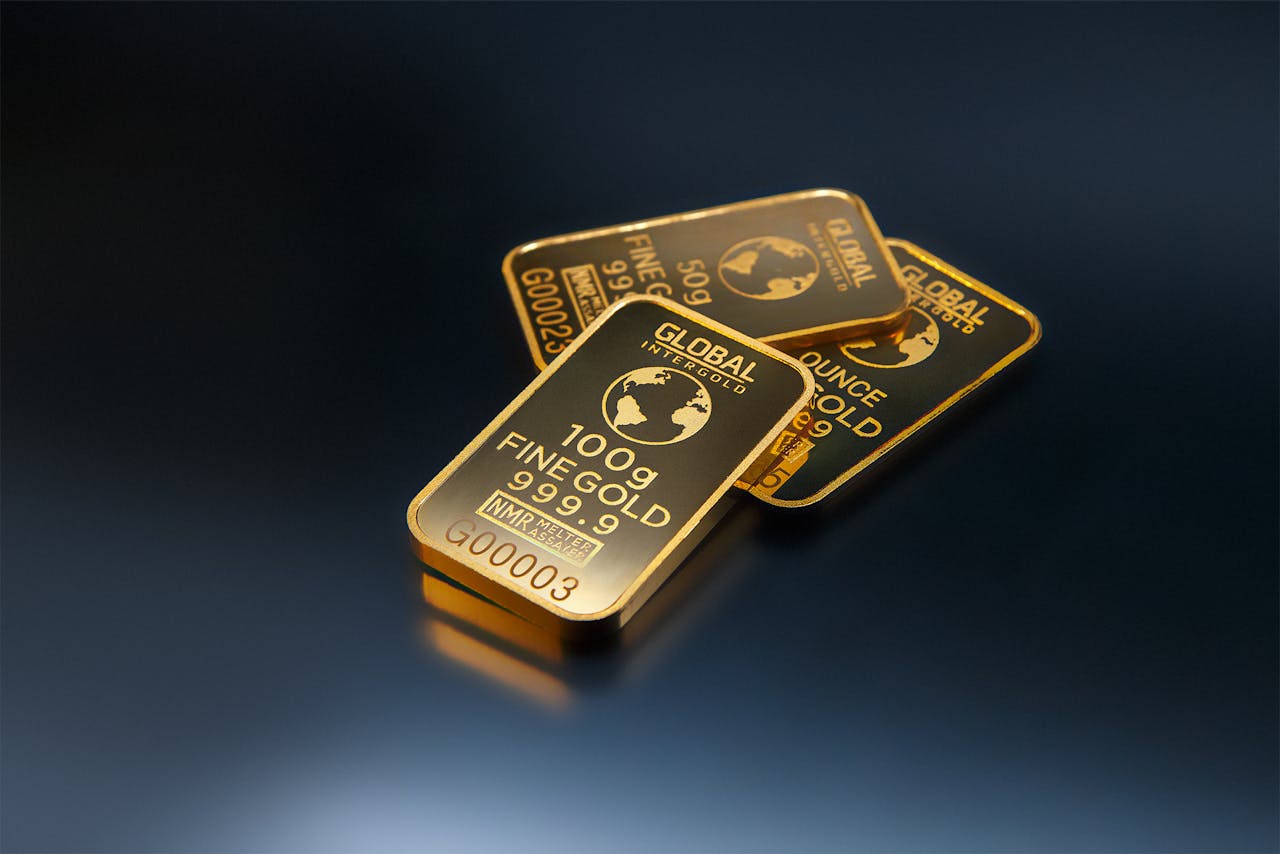 Three stamped gold bars — December gold futures traded near $4,196 to $4,198 on Monday as traders repriced the Fed's October meeting