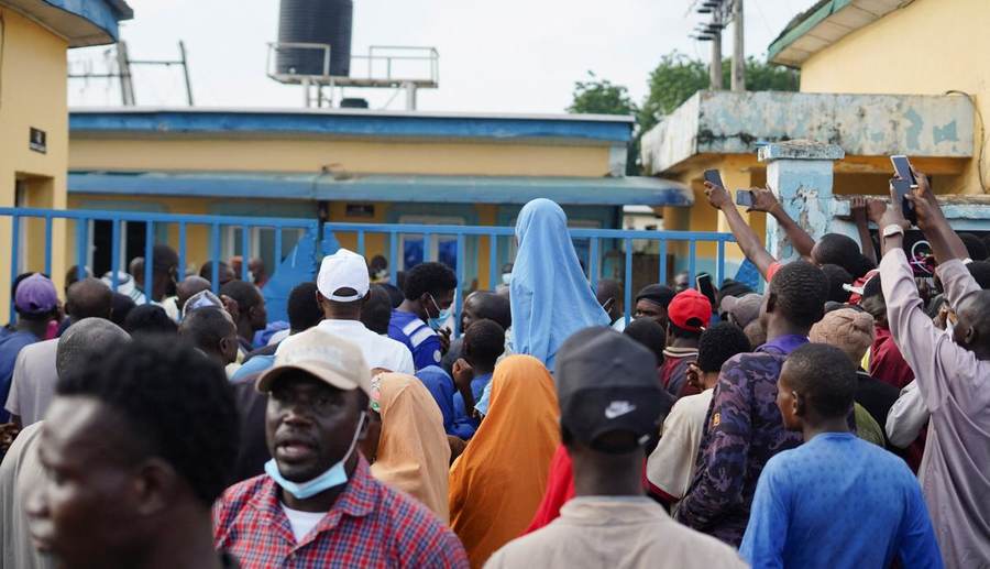 Relatives and community members gather outside General Hospital in Minna after detainees died in NSCDC custody