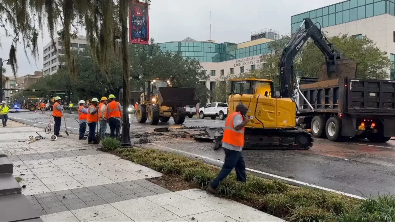 Work crews repair torn pavement on Monroe Street after the Tallahassee underground electrical fire