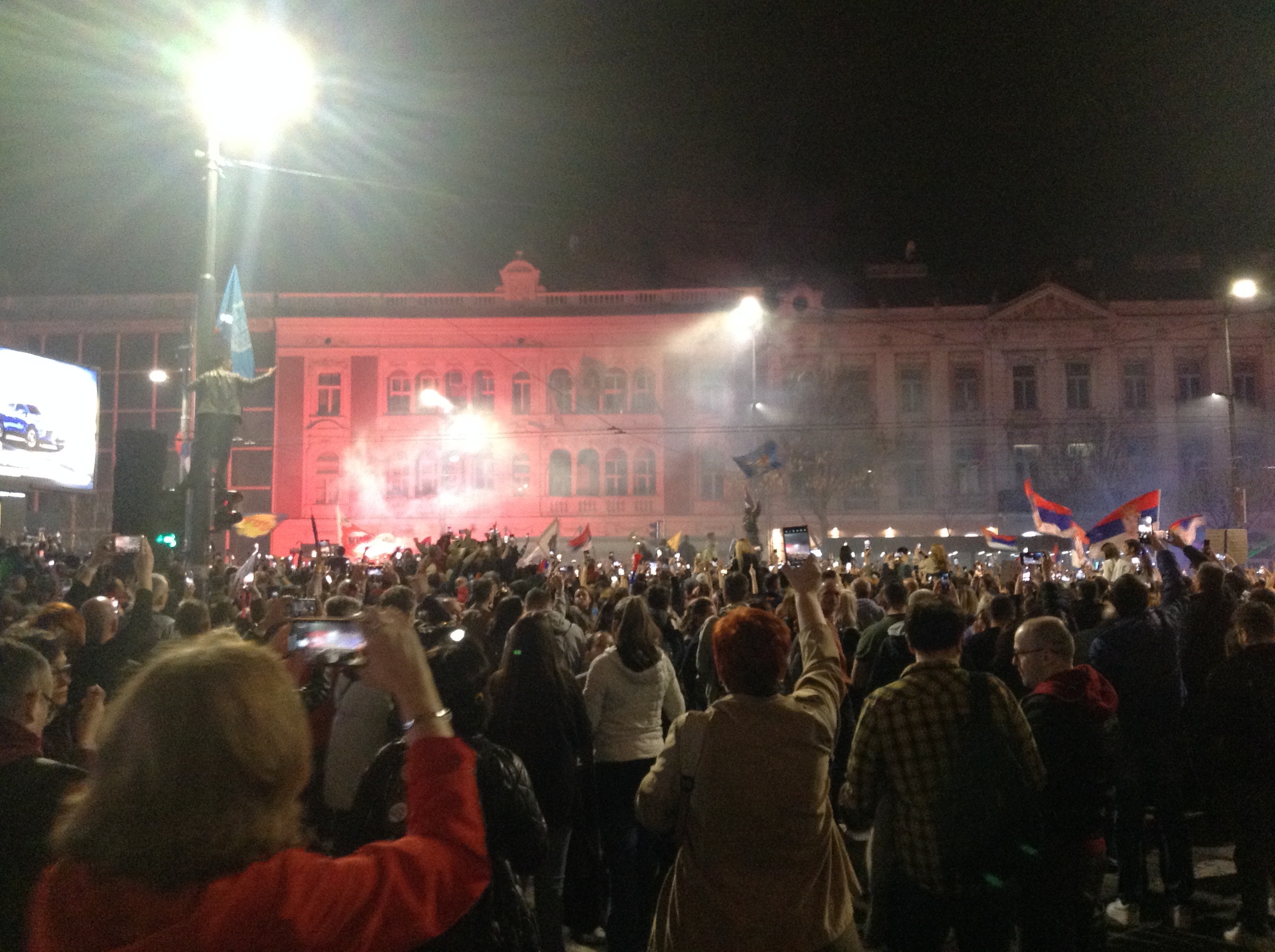 Serbia election results 2026 — a crowd waving Serbian flags fills a Belgrade square on the eve of the March 15, 2025 protest, the largest gathering of the student-led movement