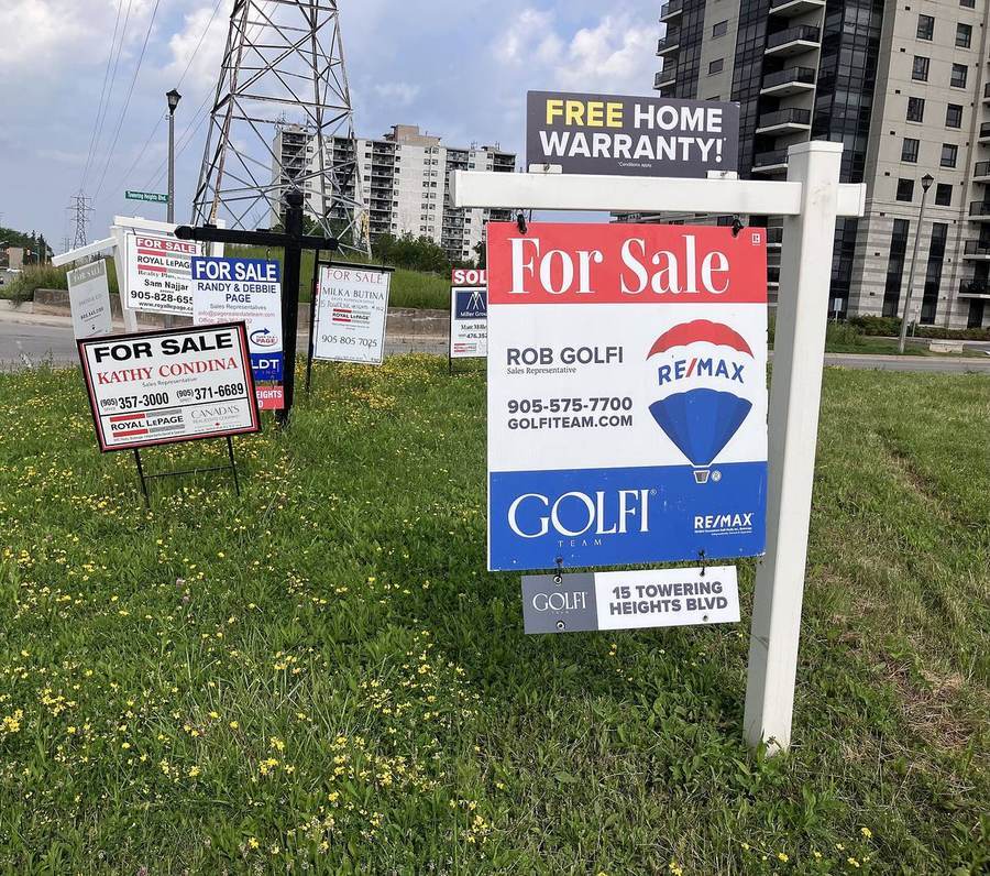 Real estate for-sale signs lined up outside homes, representing low-down-payment buying options