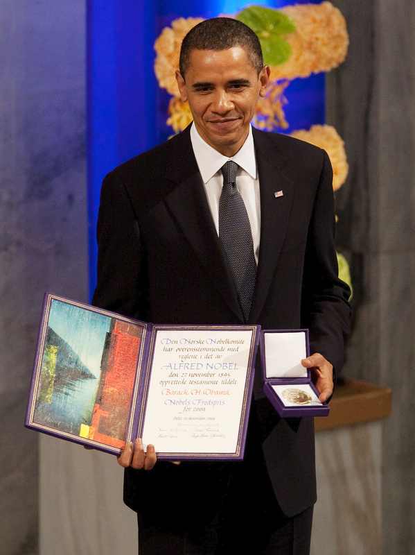 Barack Obama holding the Nobel Peace Prize medal and diploma in Oslo in 2009, the award Donald Trump cited in his Trump Nobel Peace Prize 2026 remarks